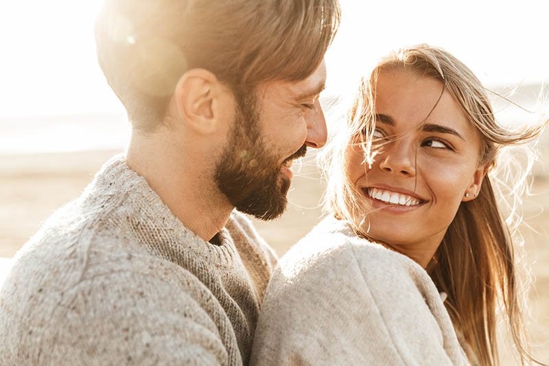 young couple looking at each other smiling